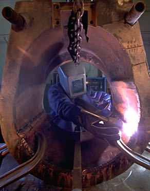 Technician working inside a furnace on-site